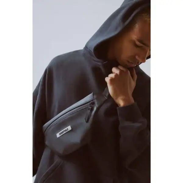 Black hoodie with a front pocket pouch, designed for casual youth fashion and streetwear.
