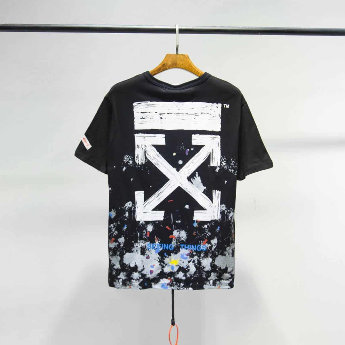 Black graphic t-shirt with paint splatter design and "SEEING THINGS" text, casual streetwear, latest cheap apparel.