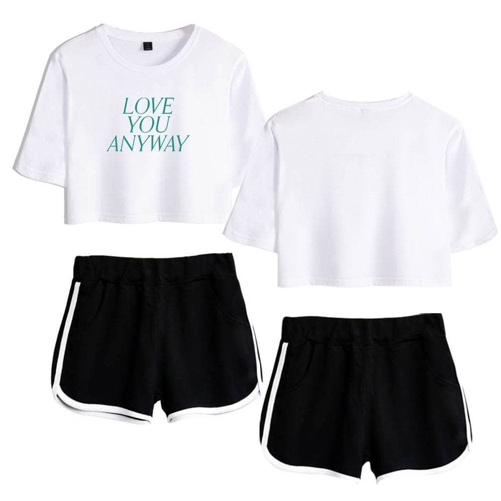 White cropped t-shirt with printed text, paired with black athletic shorts with white trim, casual summer outfit, latest cheap apparel for comfort and style, perfect for shopping or relaxing.